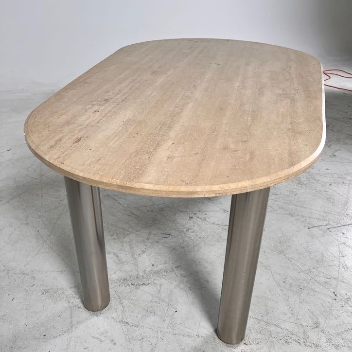 New Moe's fia dining table. travertine. Retails for $3199