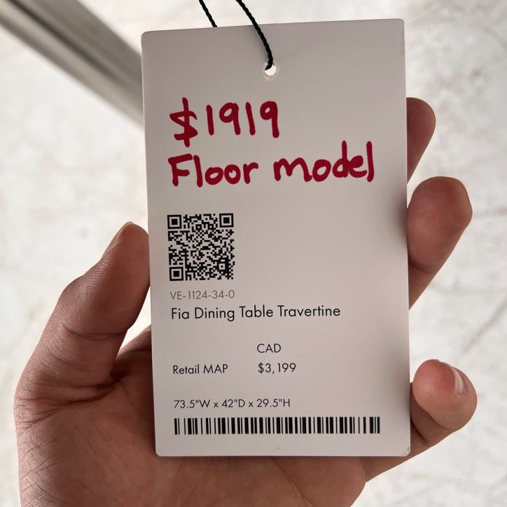 New Moe's fia dining table. travertine. Retails for $3199
