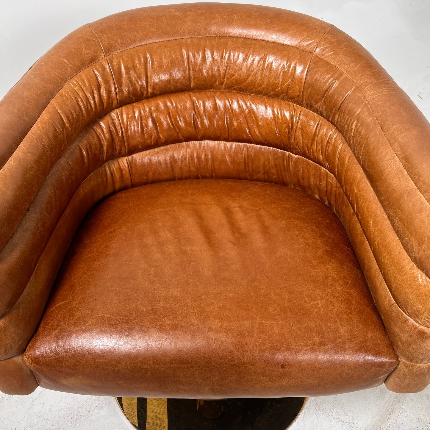CB2 swivel Armchair. Real Saddle Leather accent chair. Delivery available