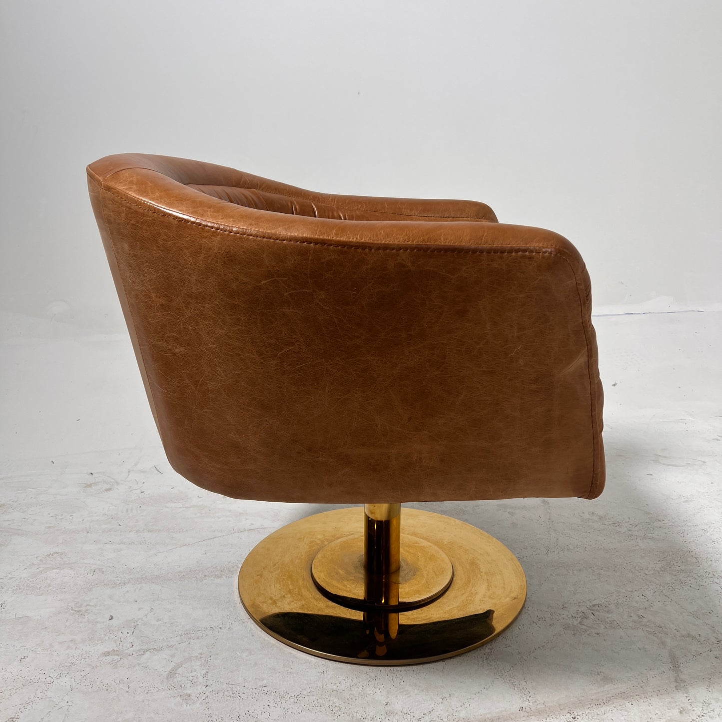 CB2 swivel Armchair. Real Saddle Leather accent chair. Delivery available