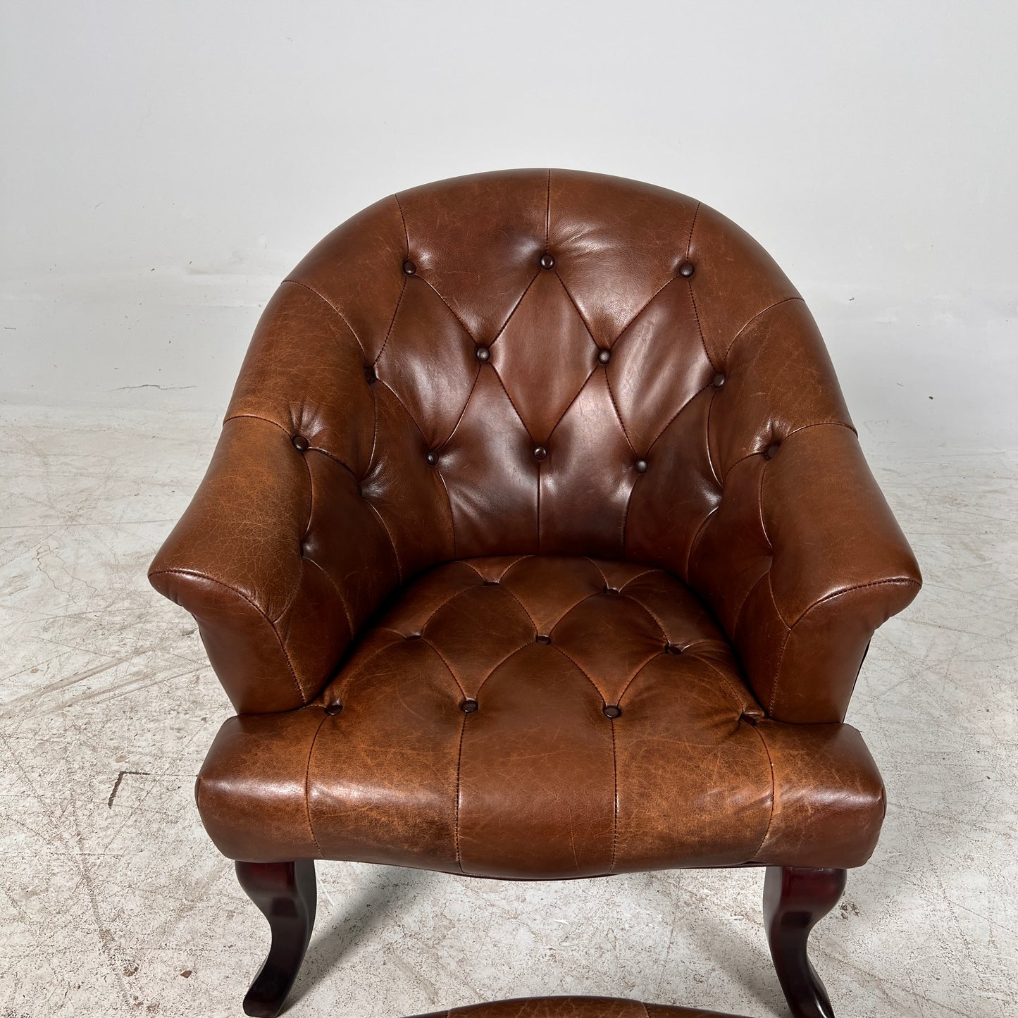 Profilia Leather Armchair plus ottoman. Decorative chair.