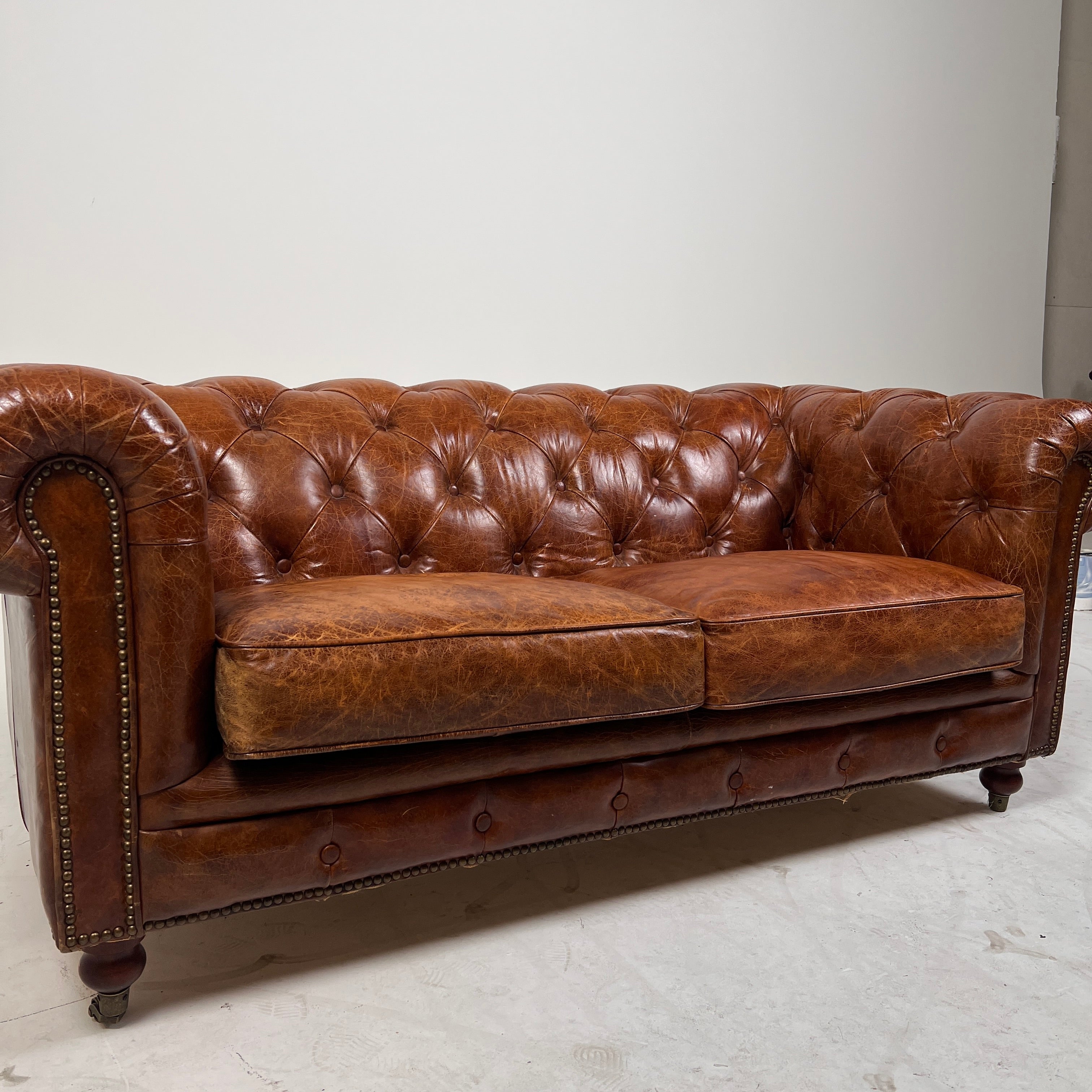 Moe's Chesterfield leather loveseat. Genuine Distressed leather sofa couch. Delivery available