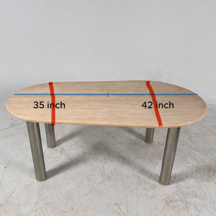 New Moe's fia dining table. travertine. Retails for $3199