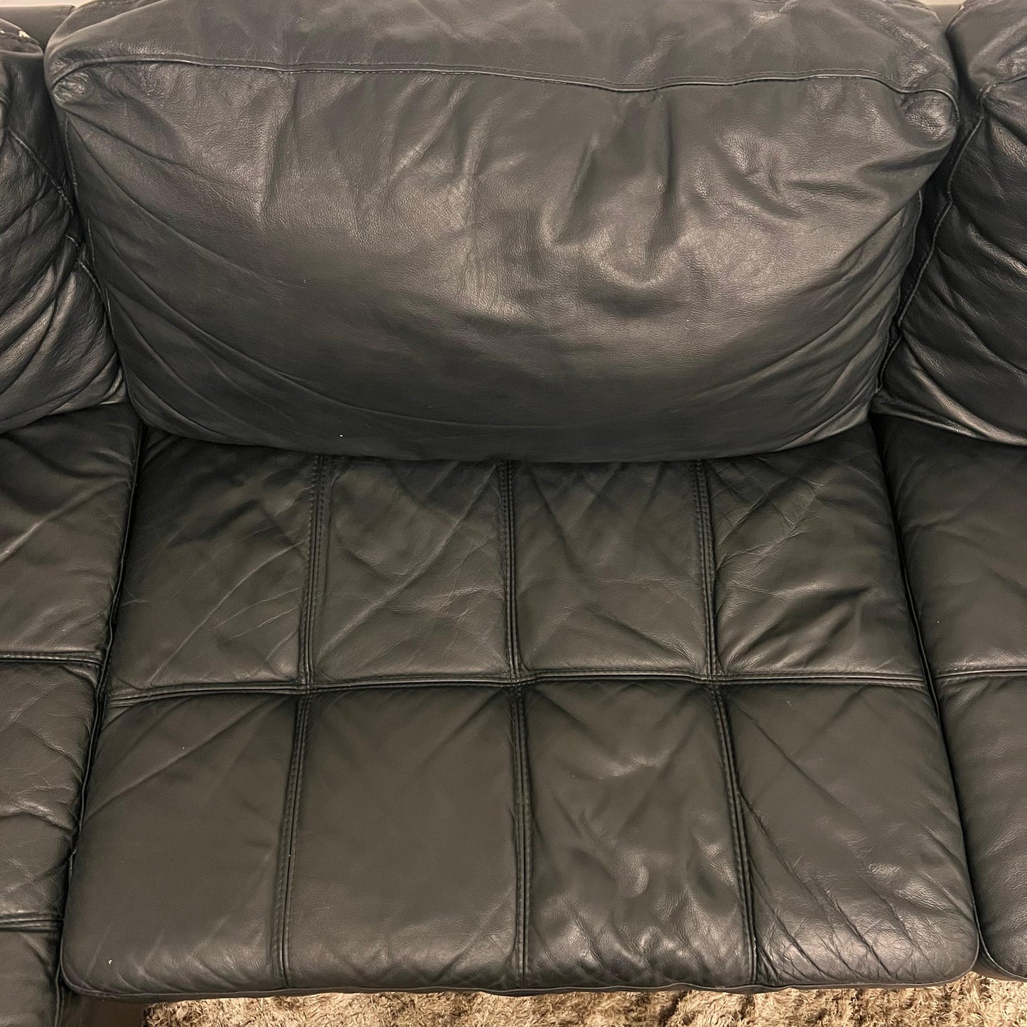Black leather sectional. L shaped sofa couch.